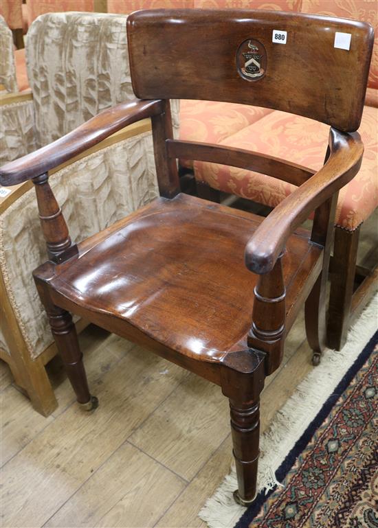 A Victorian mahogany desk chair with painted armorial